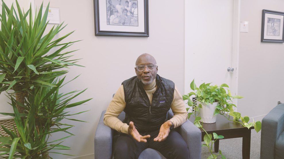 Anthony Taylor speaking on camera in an office